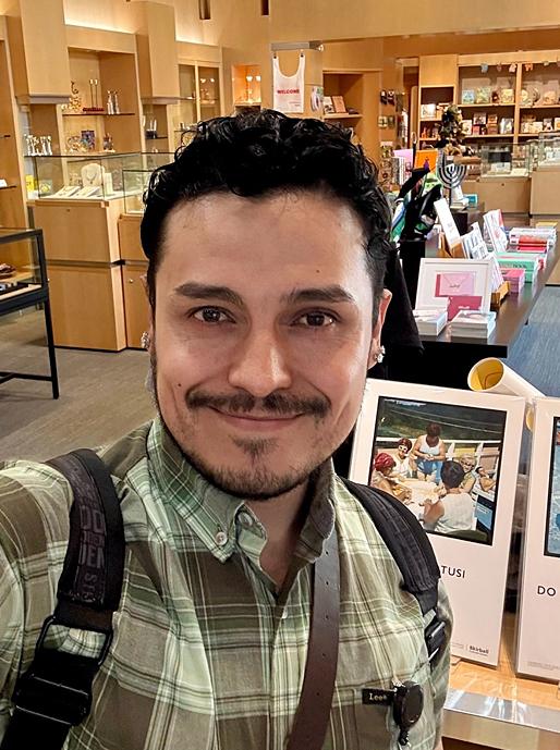 a man taking a selfie in a museum store.