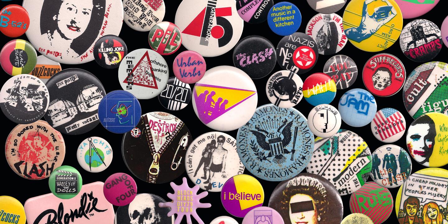 Various wearable colorful buttons with text and bands on them.