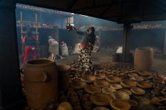An Ethiopian woman and a display of pottery