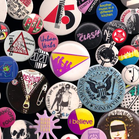 Various wearable colorful buttons with text and bands on them.